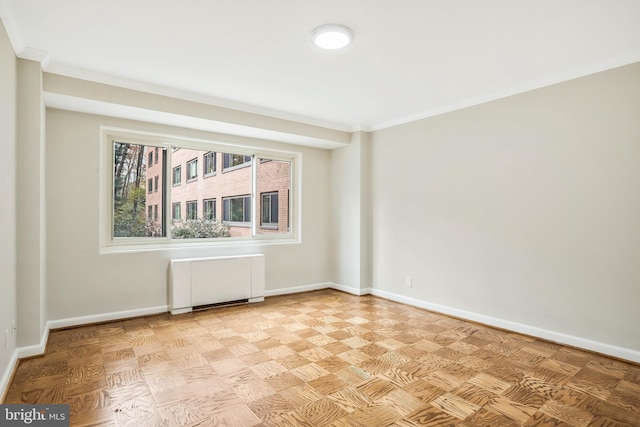 unfurnished room featuring radiator, ornamental molding, and light parquet flooring