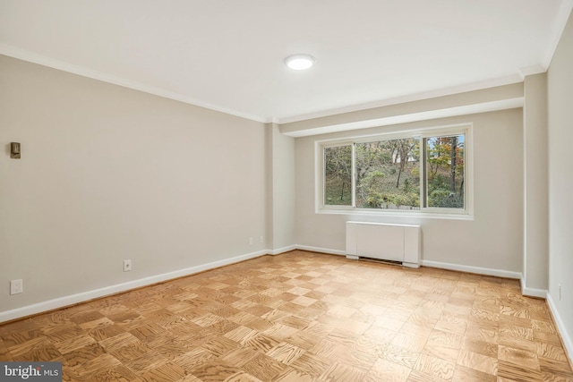 empty room with radiator heating unit and ornamental molding