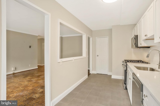 kitchen featuring white cabinetry, stainless steel appliances, and sink