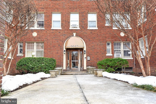 view of snow covered property entrance