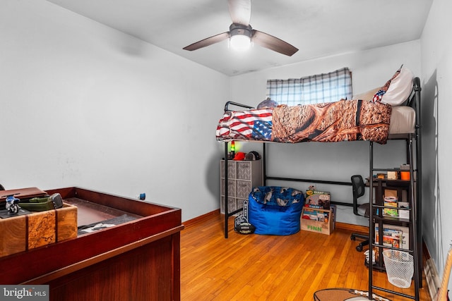 bedroom with wood-type flooring and ceiling fan