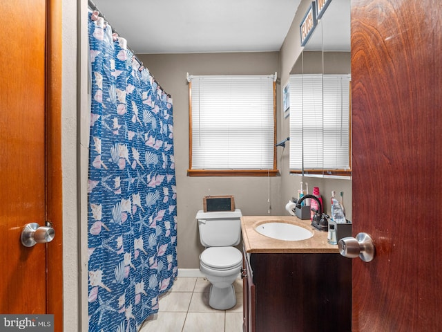 bathroom featuring vanity, tile patterned floors, and toilet