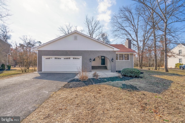 view of front of house with a garage and a front lawn