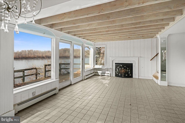 unfurnished sunroom with a water view, a chandelier, beamed ceiling, a premium fireplace, and a baseboard radiator