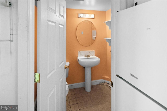 bathroom featuring tile patterned flooring and baseboards