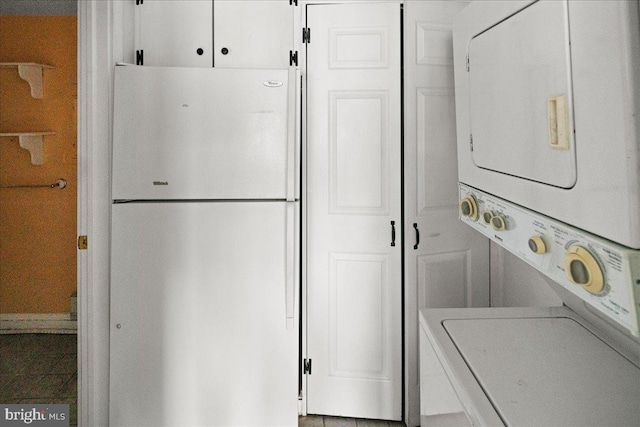 clothes washing area featuring laundry area and stacked washing maching and dryer