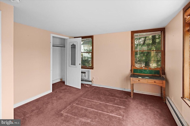 unfurnished bedroom with baseboards, carpet, an AC wall unit, baseboard heating, and a closet