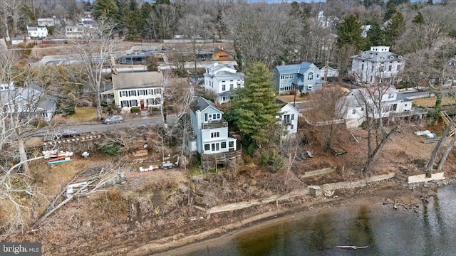 birds eye view of property with a water view and a residential view