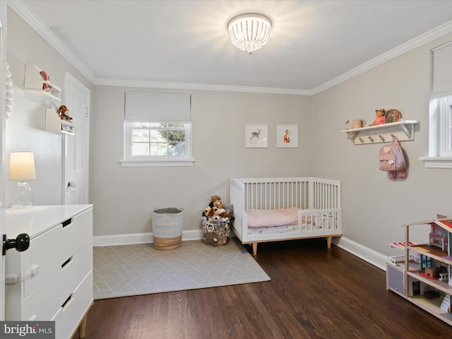 bedroom featuring dark wood-type flooring, ornamental molding, and a nursery area