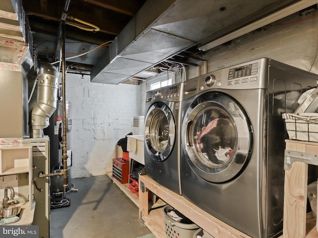 basement with separate washer and dryer and water heater