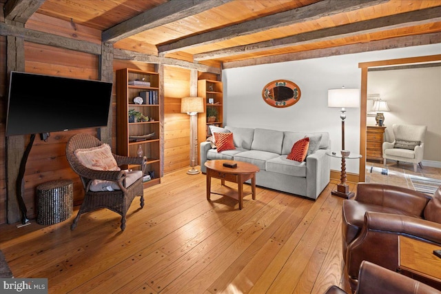 living area with wooden ceiling, light wood-style flooring, and beam ceiling