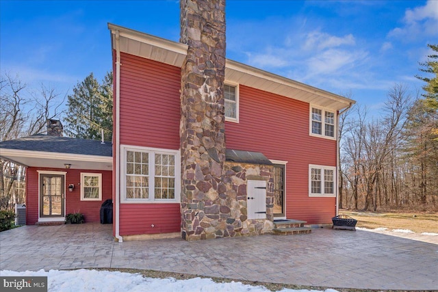 view of front of property with a patio area and a chimney