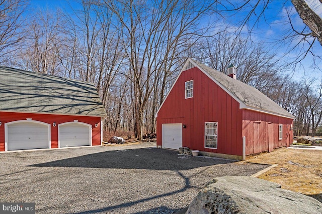 garage with a garage and gravel driveway