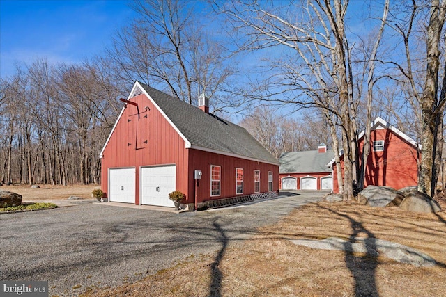 detached garage featuring aphalt driveway