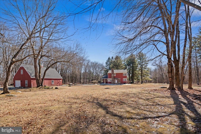 view of yard with a barn and a detached garage