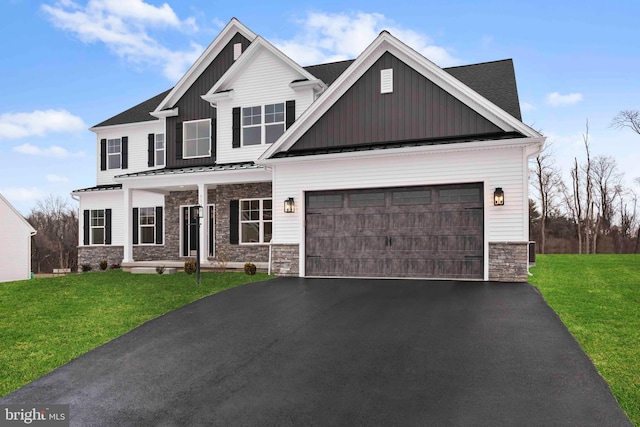 craftsman house with a garage and a front lawn