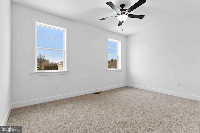 spare room featuring ceiling fan and carpet