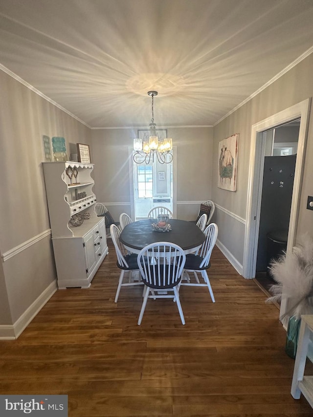 dining space featuring dark wood-style floors, baseboards, a chandelier, and crown molding