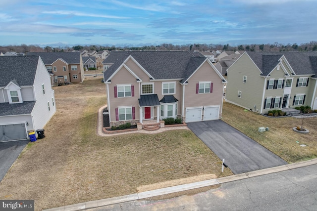 view of front of home with a garage and a front yard