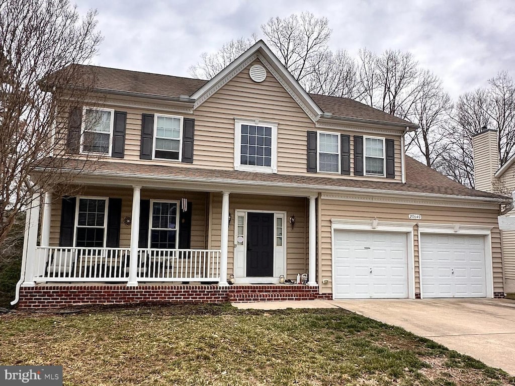 view of front facade with a garage, a shingled roof, a porch, and concrete driveway