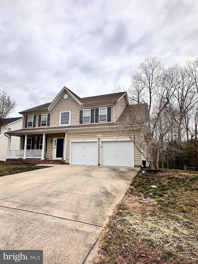 view of front of home with driveway, a porch, and an attached garage