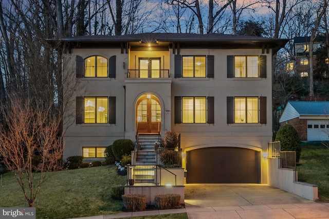 view of front of property featuring a garage and a yard