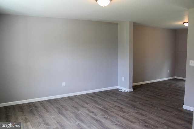 spare room featuring dark hardwood / wood-style flooring