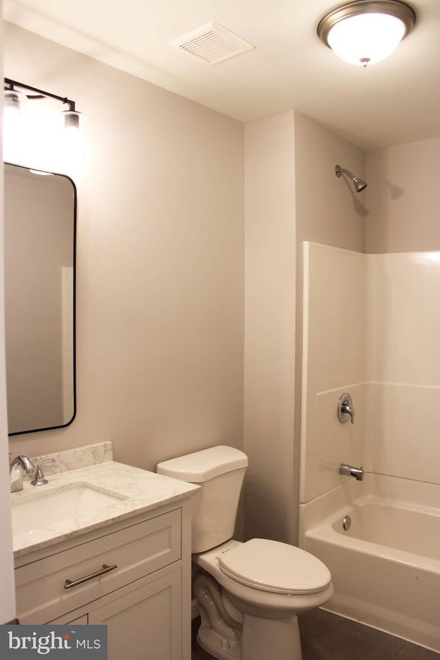 full bathroom featuring toilet, vanity, and bathtub / shower combination