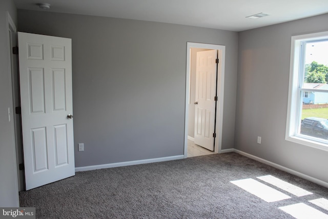 empty room with light colored carpet