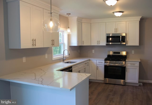 kitchen with pendant lighting, white cabinetry, sink, kitchen peninsula, and stainless steel appliances