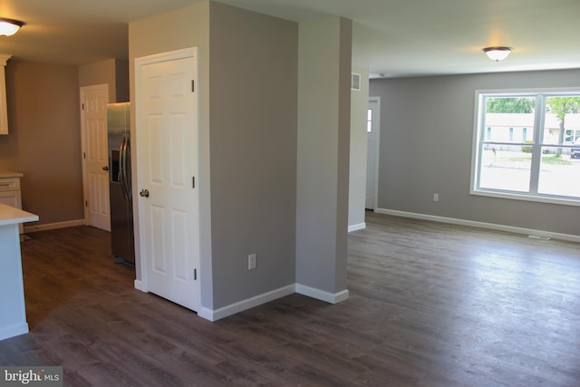 empty room with dark hardwood / wood-style floors