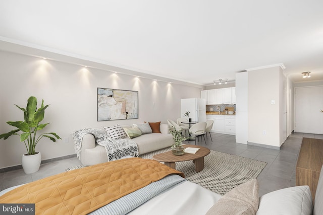 living room featuring crown molding, tile patterned floors, and rail lighting