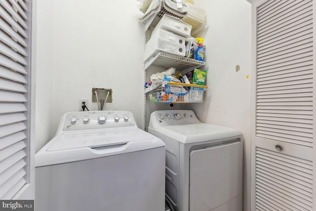 clothes washing area with separate washer and dryer