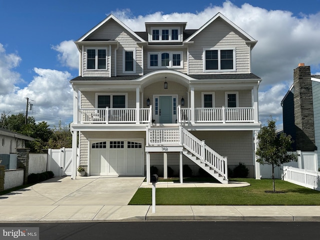 view of front of home featuring a garage, a front lawn, and a porch