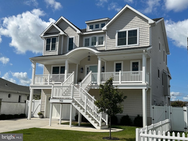 coastal home with a porch and a front yard