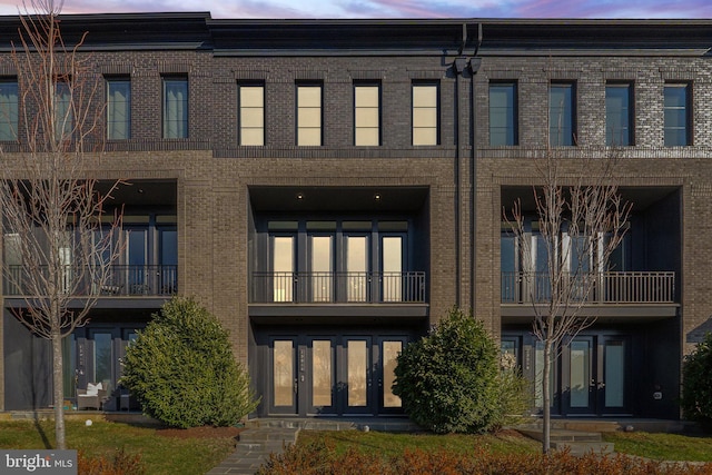 view of outdoor building at dusk