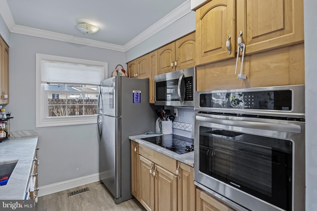 kitchen featuring visible vents, appliances with stainless steel finishes, light countertops, and ornamental molding