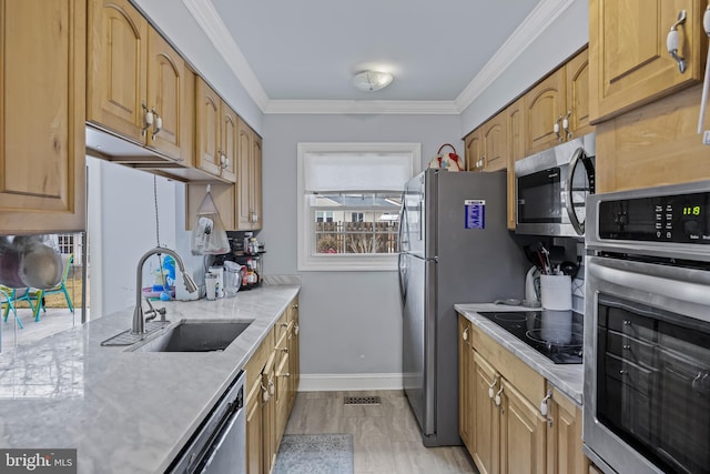 kitchen featuring light stone counters, crown molding, stainless steel appliances, a sink, and baseboards