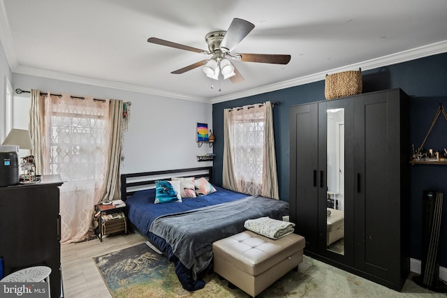 bedroom with ornamental molding, light wood-type flooring, and a ceiling fan