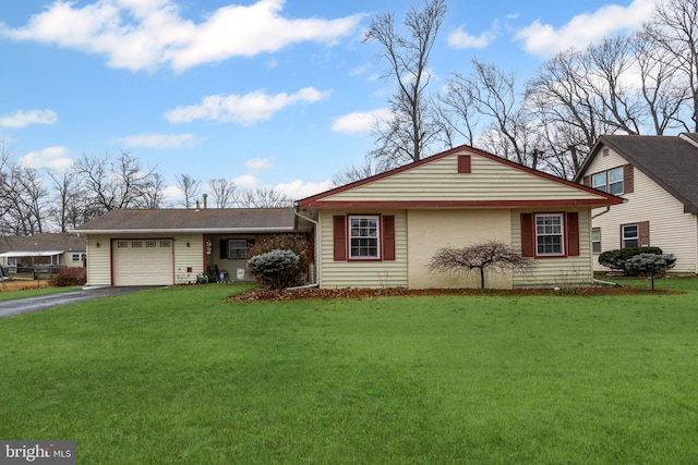 ranch-style home with a garage, aphalt driveway, and a front lawn