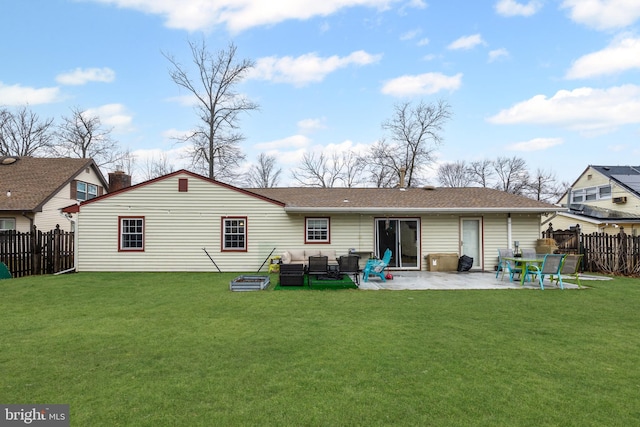 rear view of house with a patio area, fence, and a yard