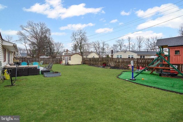 view of yard featuring a playground, outdoor lounge area, a storage shed, a fenced backyard, and an outdoor structure