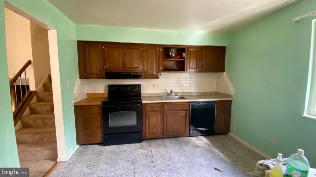 kitchen with sink, decorative backsplash, and black appliances