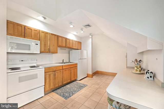 26372 Westerly Rd, Easton, MD 21601 - kitchen with white appliances, vaulted ceiling, light countertops, light tile patterned floors, and a sink