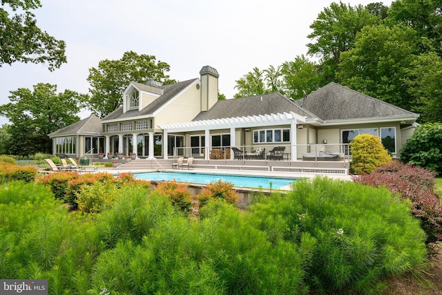 26372 Westerly Rd, Easton, MD 21601 - back of property featuring a pergola, a patio area, an outdoor pool, and a chimney
