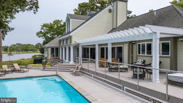 26372 Westerly Rd, Easton, MD 21601 - back of property with a shingled roof, an outdoor pool, and a chimney