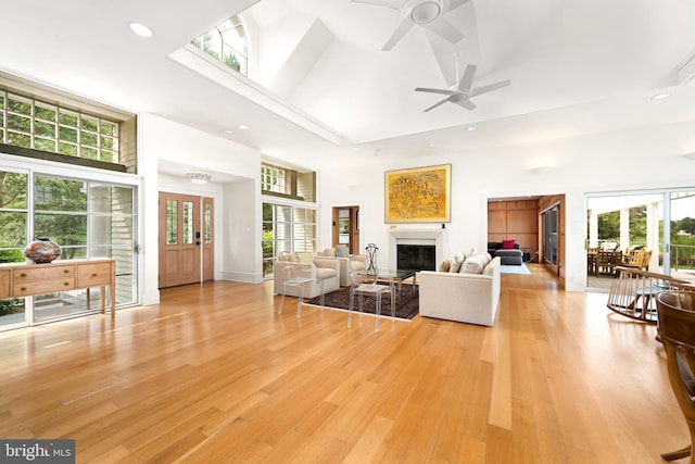 26372 Westerly Rd, Easton, MD 21601 - living room with a high ceiling, a ceiling fan, recessed lighting, a glass covered fireplace, and light wood finished floors