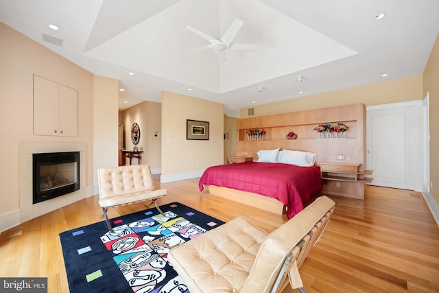 26372 Westerly Rd, Easton, MD 21601 - bedroom with recessed lighting, a glass covered fireplace, light wood-style flooring, ceiling fan, and baseboards