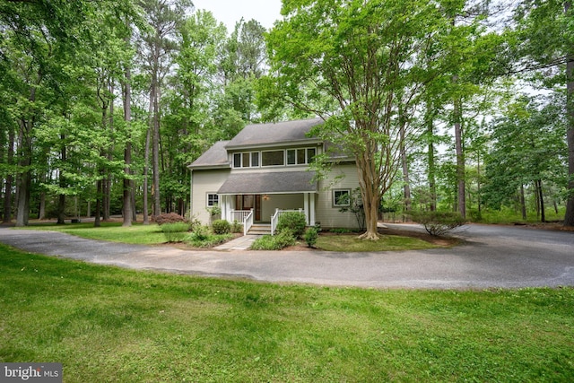 26372 Westerly Rd, Easton, MD 21601 - view of front of home with asphalt driveway, a porch, a front lawn, and a shingled roof