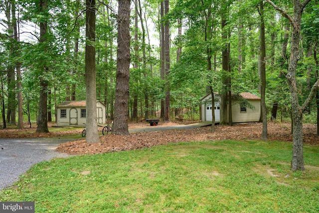 26372 Westerly Rd, Easton, MD 21601 - view of green lawn with an outbuilding, a detached garage, and driveway